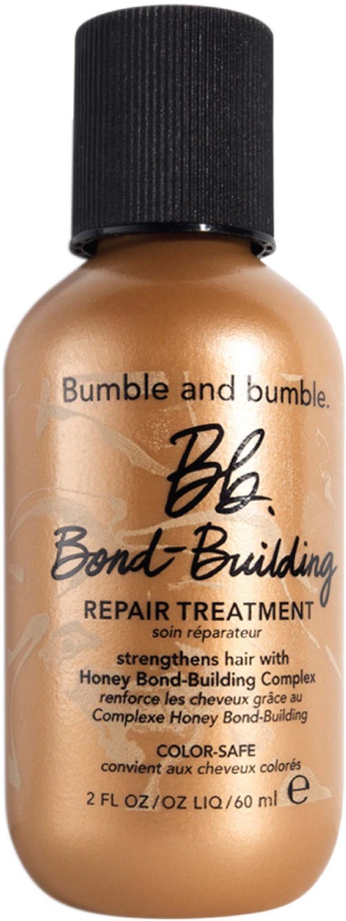 A small bottle of Bumble and Bumble Hair Bond-Building Repair Treatment, in tan color with black cap, 2 fl oz (60 ml).