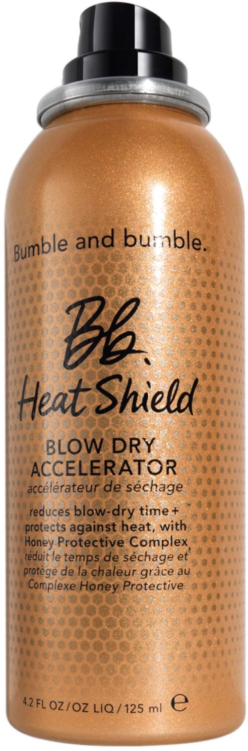 En guldfärgad flaska från Bumble and bumble Heat Shield Blow Dry Accelerator med svart lock och produktdetaljer.