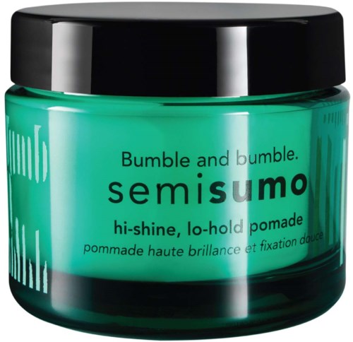 Een turquoise pot met zwarte deksel met Semisumo pomade voor glanzend, gemakkelijk te stylen haar.