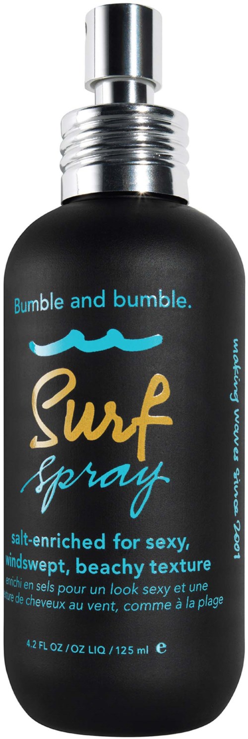 Czarna butelka spray z srebrnym korkiem, oznaczona 'Bumble South Surf Spray' w niebieskim tekście, z ikoną słońca i fali.