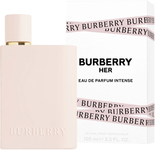 A light pink perfume bottle with a white and gold cap and a white box with black and pink details.