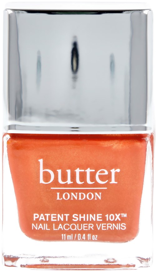 Tölkin oranssia kynsilakkaa Butter Londonilta, hopeanvärisellä kannella ja läpinäkyvässä pullossa, jossa väri näkyy.