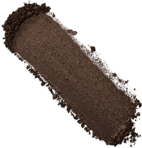 A thick, cylindrical dollop of brown makeup or pigment with some loose particles around it.