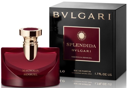 A perfume bottle with a round red base and a gold cap, next to a black box with gold and red details.