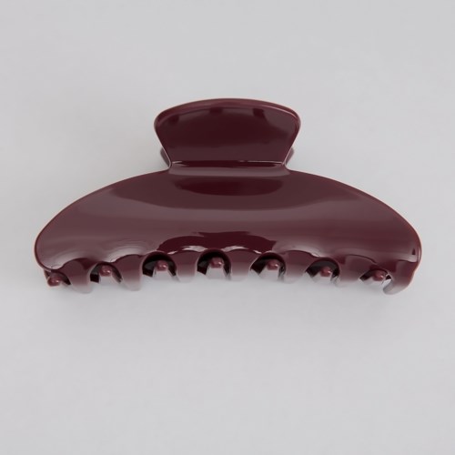 A maroon hair clip with a curved shape and large teeth.