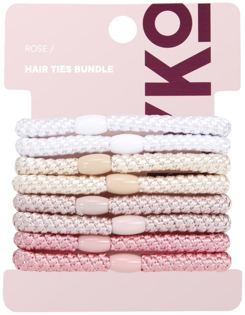 Ett paket med åtta hårband i vitt, beige och rosa färger på ett rosa kort.