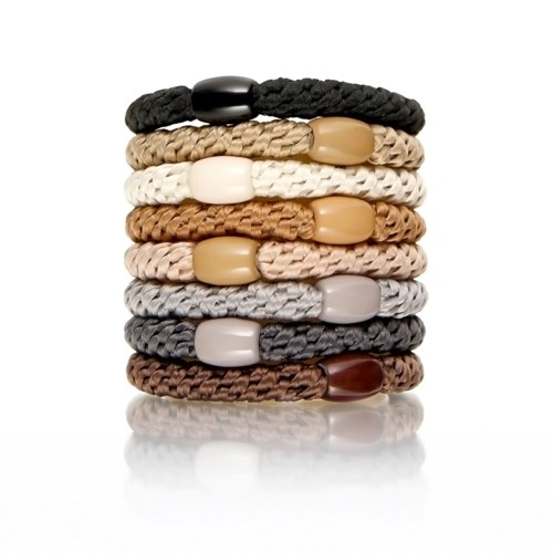 Stapling av nio flätade armband i svart, brunt, vitt, beige, grått och mörkbrunt med stora pärlor.
