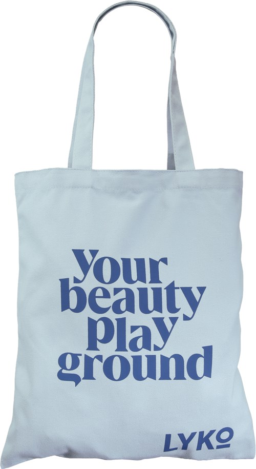 En hvid tote bag med blå tekst, der siger "Your beauty playground" og en lille logo i bunden.