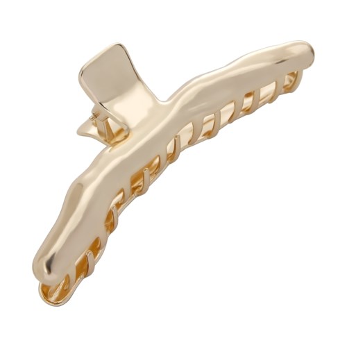 A shiny gold hair clip with a curved shape and small teeth to hold hair.