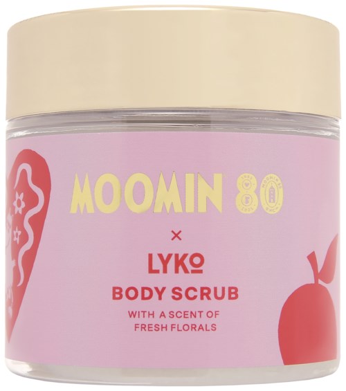 A pink jar with a cream lid contains Moomin-themed Lyko body scrub with floral scent and red apple illustration.