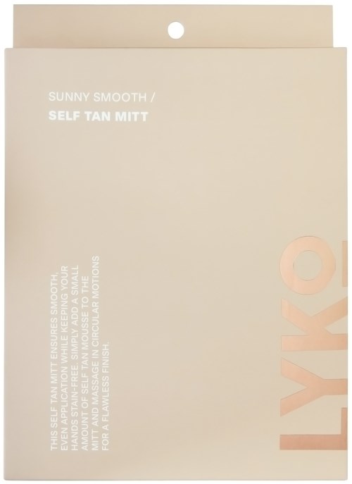 A peach-colored package with white and pink text, promoting a self-tan mitten for smooth, sunny skin.