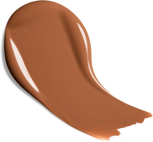A dollop of creamy, light brown liquid spreads on a white background, with a glossy finish and smooth texture.