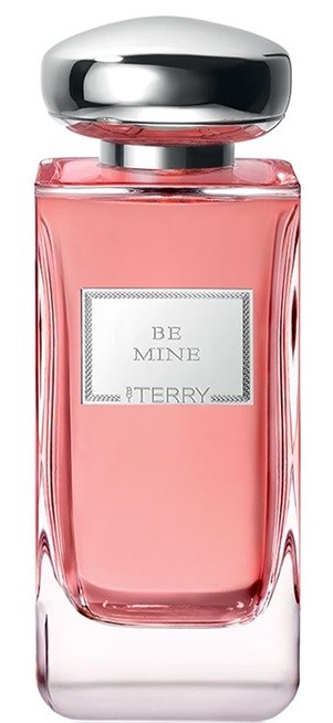 En rosa parfymflaska med silverlock och en etikett som säger "BE MINE" och "TERRY."