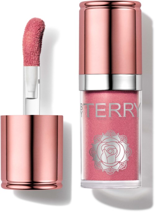 Pink lip gloss with a metallic case next to a matching pink nail polish with a rose design label.