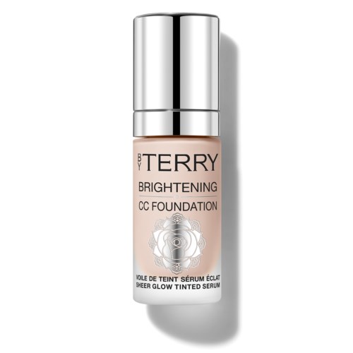 En liten beige flaske med sølvhette merket 'BY TERRY Brightening CC Foundation' og en rosedesign.