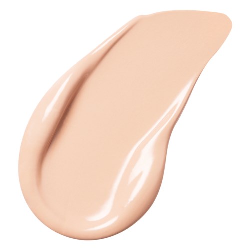 En dråpe med beige-aktig væske, glatt og skinnende, med spiss tupp og avrundet bunn.