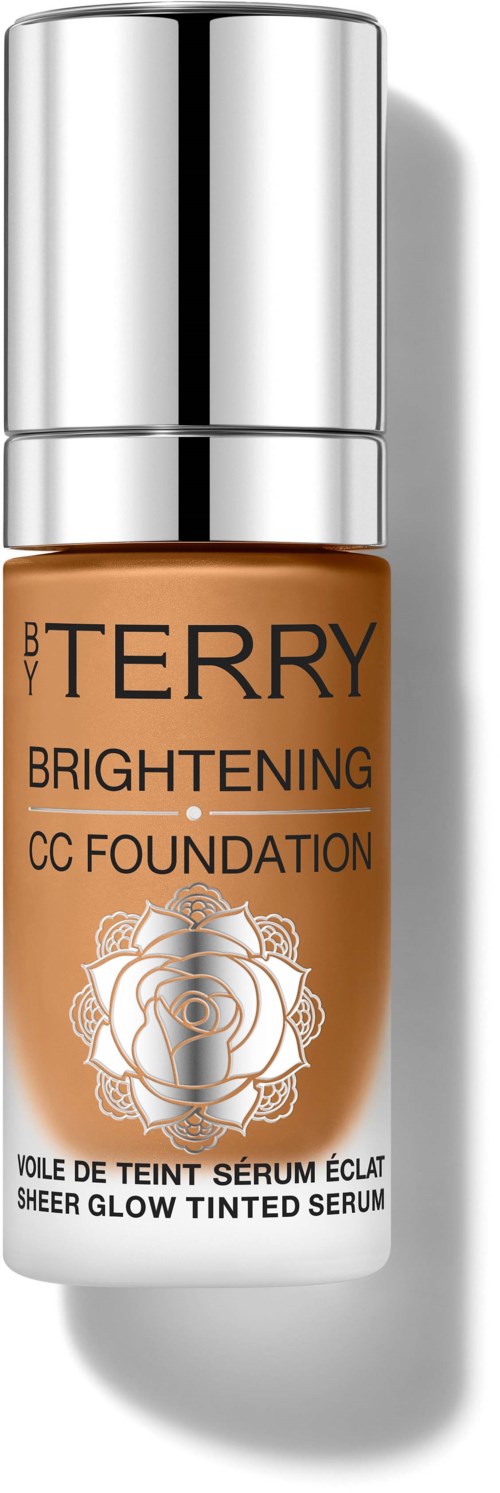 En flaske Bobbi Brown Brightening CC Foundation med sølvhette og etikett med rosedesign.