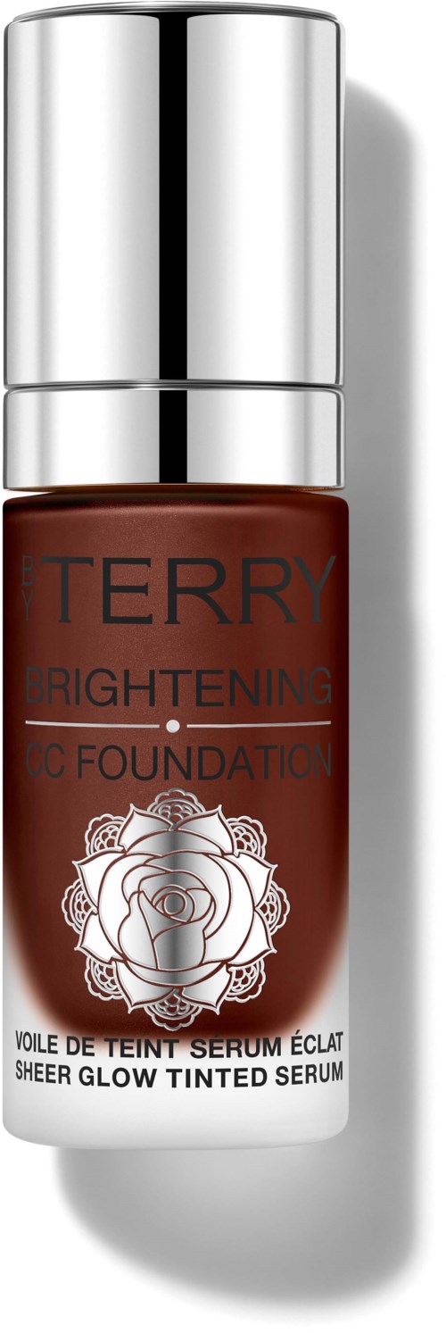 En liten flaske med tonet serum med sølvhette, merket 'TERRY Brightening Sheer Glow Tinted Serum'.