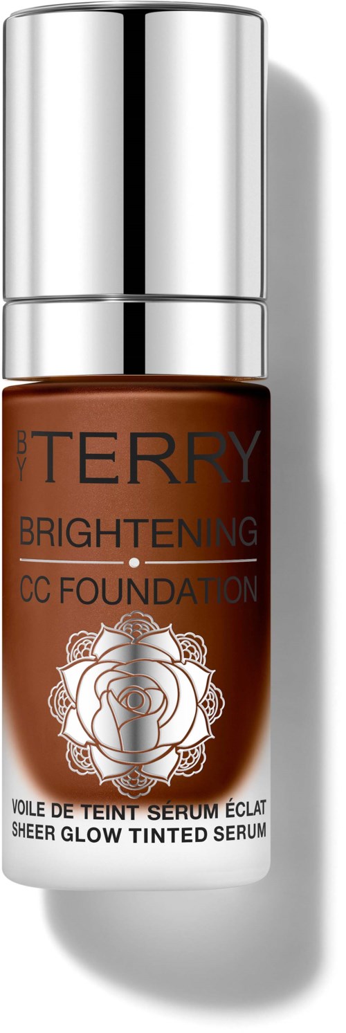 En liten brun flaske med sølvtopp, merket 'Terry Brightening CC Foundation' med en rose-logo.