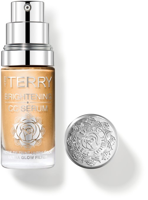 En flaska av By Terry Brightening CC Serum med silverlock och rosetlogo, och en rund silverförpackning.