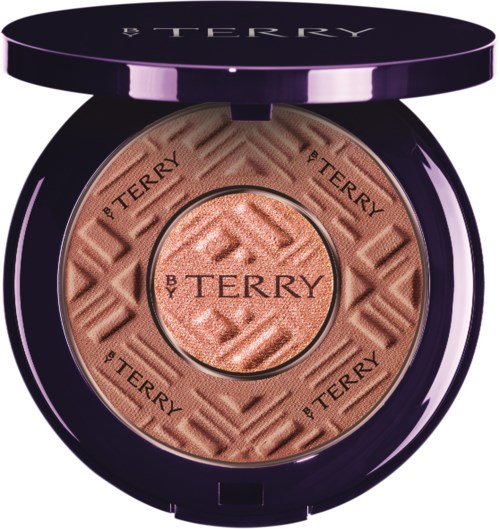 Pink blush inside a dark purple compact with the brand name 'BY TERRY' engraved around the center.