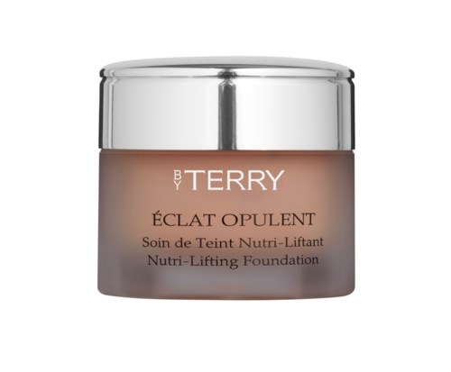 En burk med Terry Éclat Opulent Nutri-Lifting Foundation med silverlock och beige behållare. Texten på burken beskriver produkten.