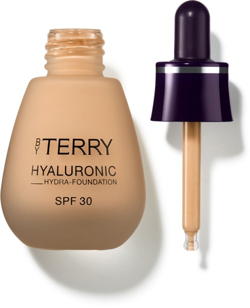 En beige foundationflaske med svart lokk, ved siden av en dropper, merket 'HYALURONIC SPF 30'.