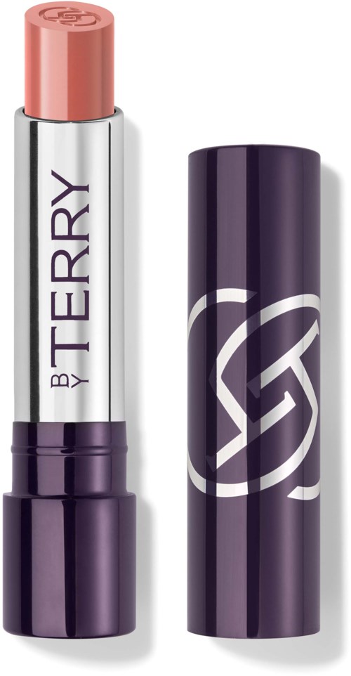 Lip balm tube with 'BY TERRY' logo, partially open showing peach-colored balm, purple cap beside it.