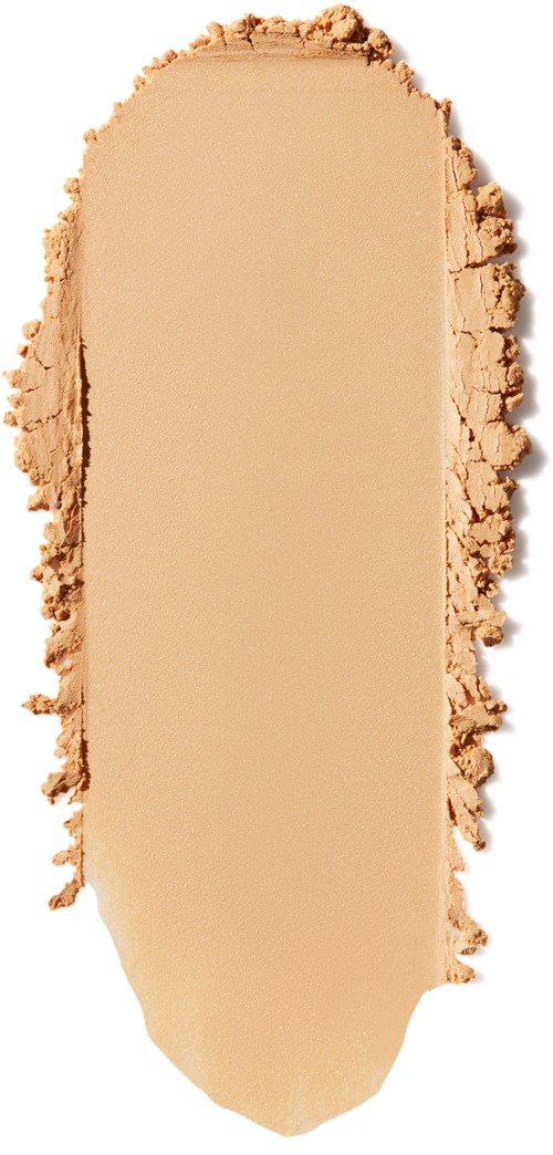 Ett beige ansiktspuder med ojämna kanter, formad som en rundad rektangel.