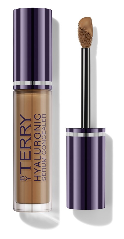 A beige liquid concealer in a purple tube with a wand applicator beside it.