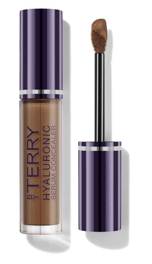 The image shows a liquid concealer in a purple and silver tube with a wand applicator.