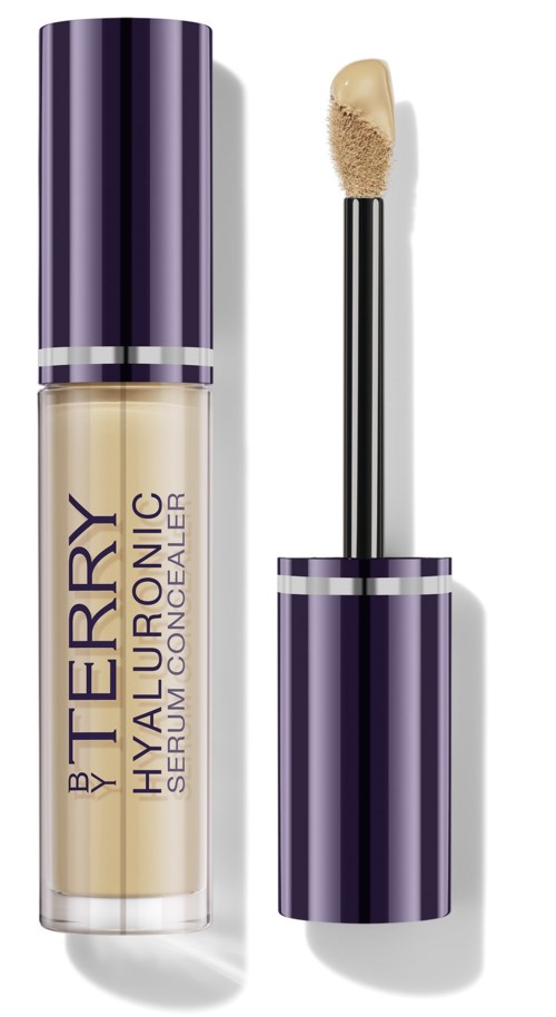 A clear bottle of concealer with a purple cap, and an applicator with a sponge tip. The label shows the product name.