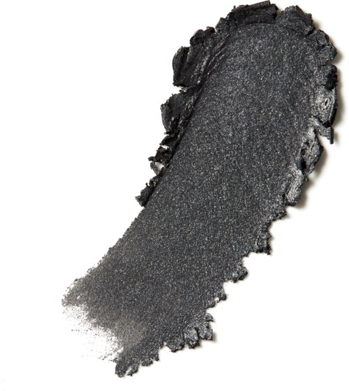 A black, powdery substance spread out with rough edges, resembling chalk or charcoal.