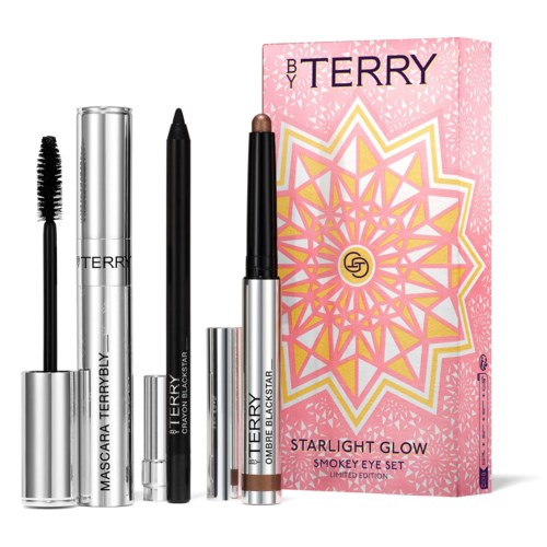 Makeup-produkter och en rosa box med geometrisk design, märkt 'Starlight Glow' och 'Smokey Eye Set.'