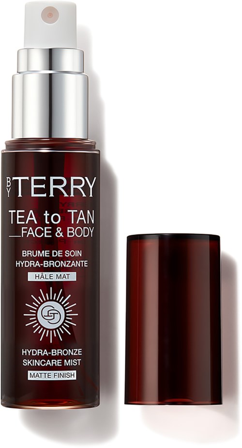 A bottle of tanning face and body mist with a spray top and a separate cap. The label has red, black, and white colors.