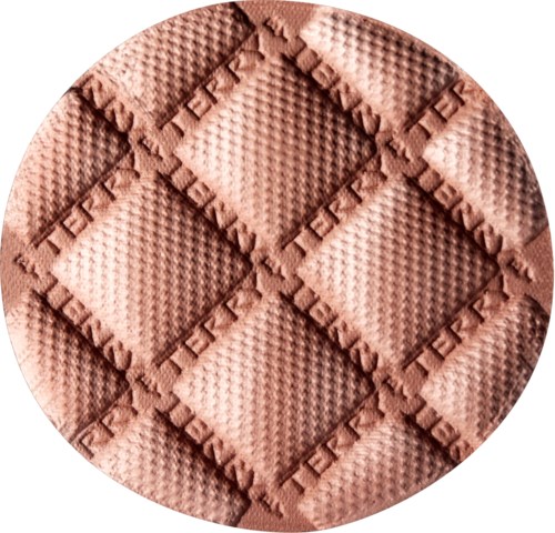 A circular, textured surface with a pattern of raised squares and intricate borders.