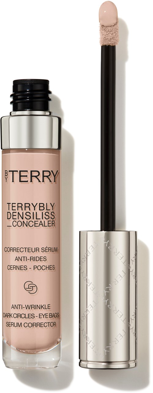Ett tub med concealer med en applikator och beige flytande inuti.