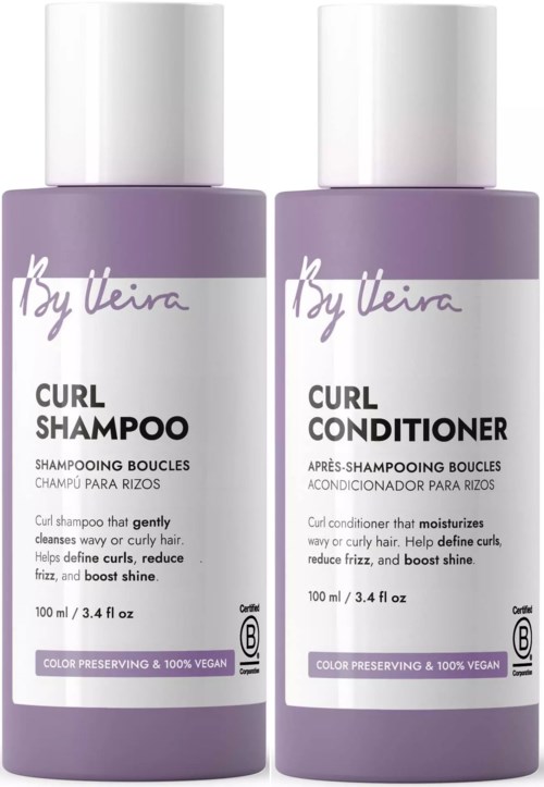 Two white bottles of By Vila curl shampoo and conditioner with purple labels facing forward.