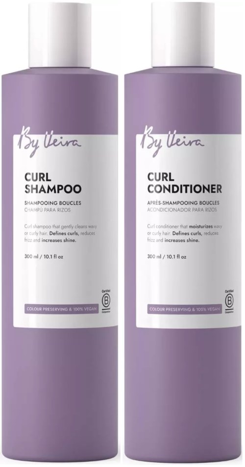 Two bottles of purple hair care products, one labeled curl shampoo and the other curl conditioner.