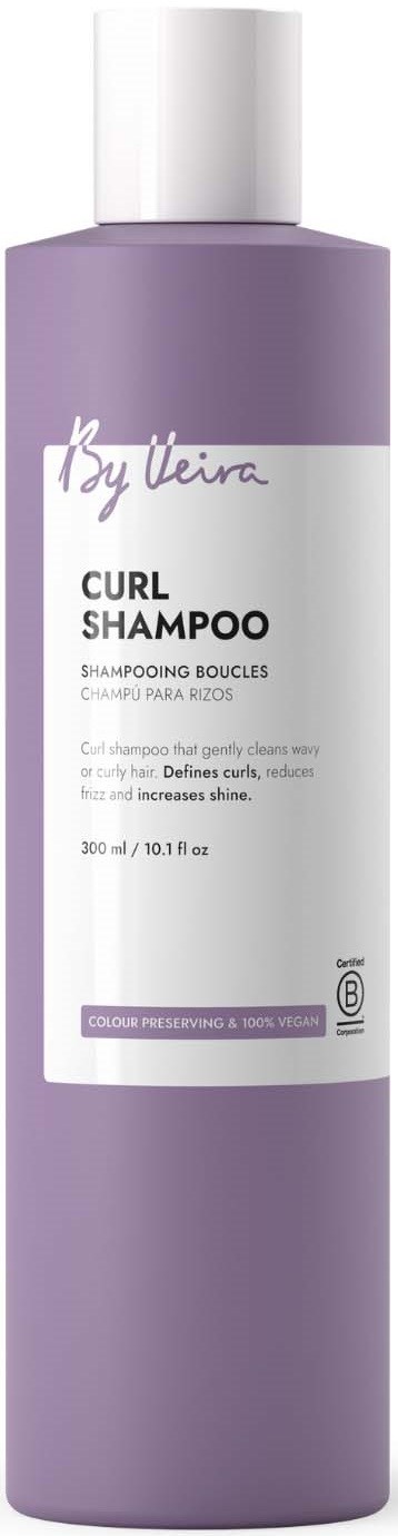 A tall lavender bottle of By Elle Curl Shampoo with a white pump cap and label, showing product details.