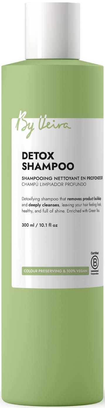 A tall, light green bottle of detox shampoo with a white cap and label showing product details.