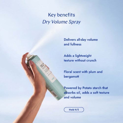 Can of dry volume spray releasing mist, with key benefits listed beside, including lightweight texture, floral scent, and buildup absorption.