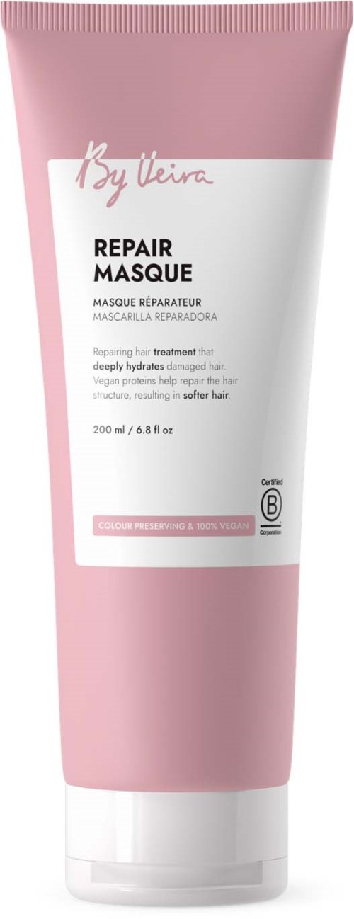 Pink tube of repair hair mask with white label displaying product name and description.