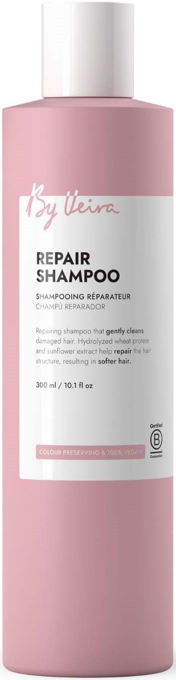 Pink bottle of repair shampoo with white label and cap, featuring brand name and product details.