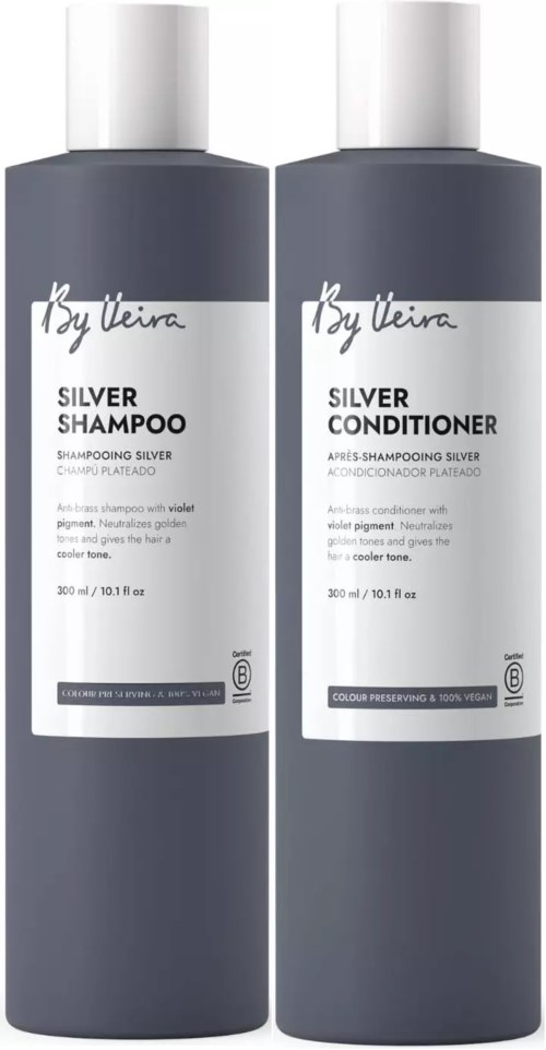 Two dark gray bottles of hair shampoo and conditioner with white caps and labels.