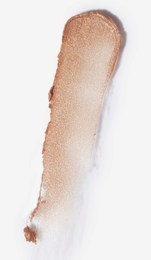 A beige, elongated makeup product with a rounded tip, possibly a foundation or concealer stick.