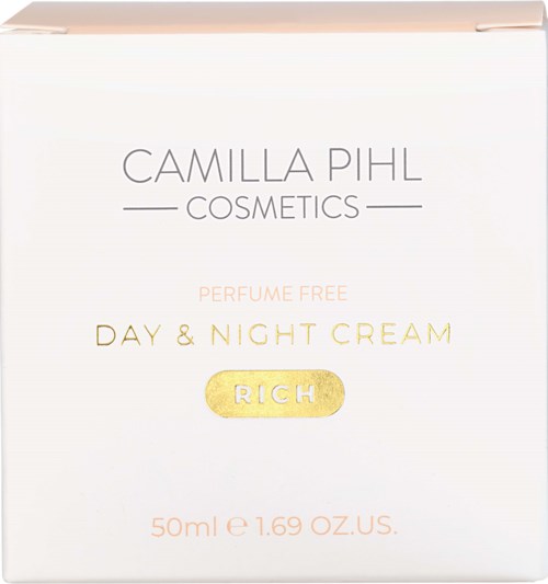 Valkoinen rasia, jossa kultaisia ja pinkkejä tekstejä Camilla Pihl Cosmeticsin hajustamattomasta päivä- ja yövoiteesta.
