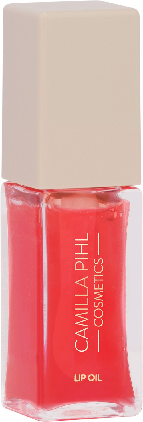 A red lip oil in a transparent bottle with a white cap, labeled "Camilla Phil Cosmetics."