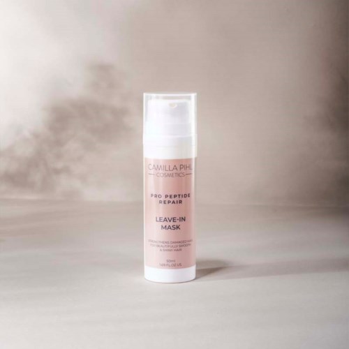 A white bottle with pink label says 'Camilla Pihl Cosmetics, Pro Peptide Repair, Leave-in Mask.'