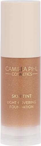 A foundation bottle with a light brown color, labeled 'Camilla Pihl Cosmetics Skin Tint.'